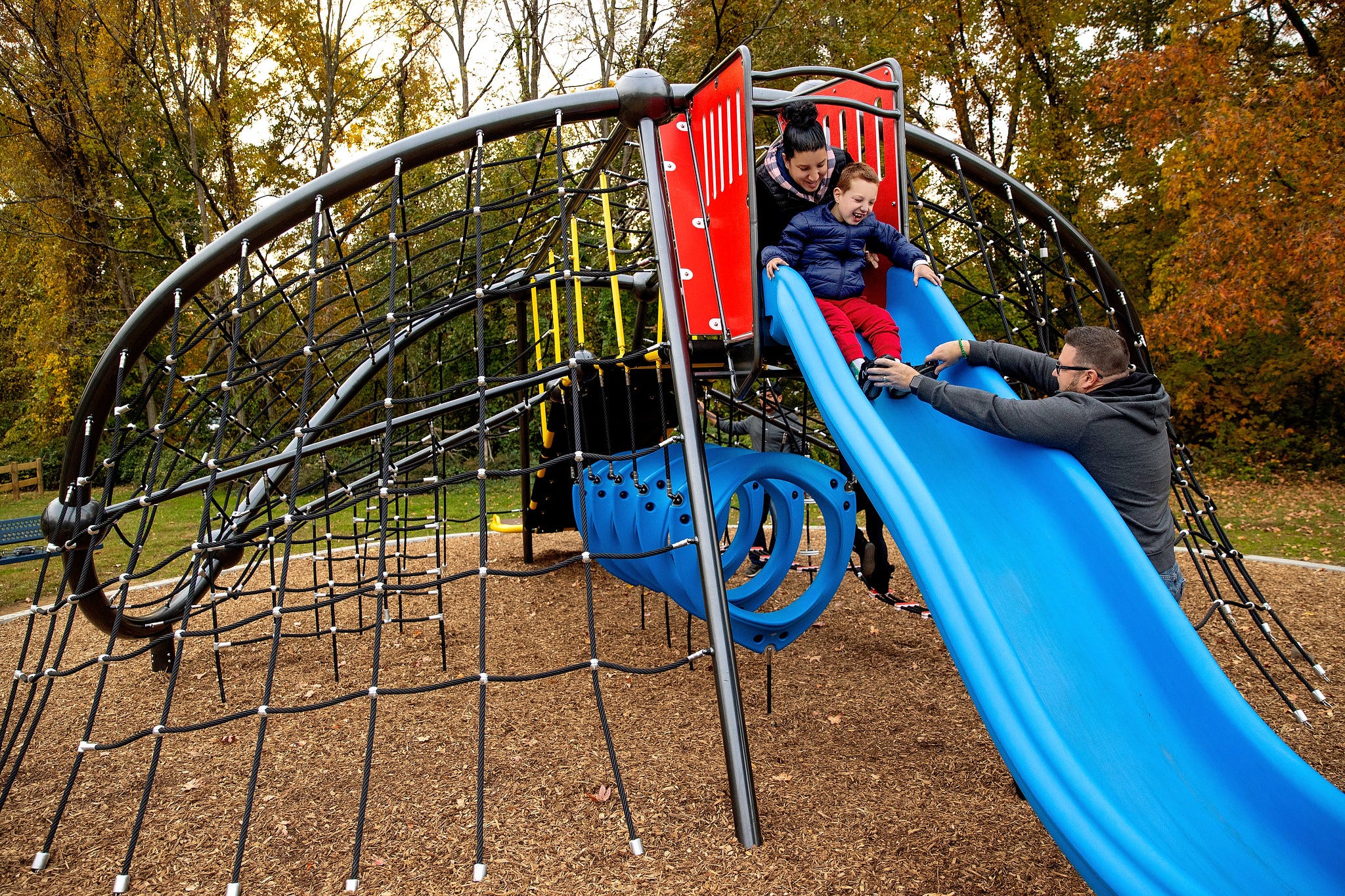 Family playing on GT Wave Net Climber from GameTime