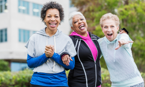 Women laughing and exercising outdoors