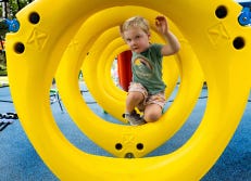 Preschool age boy climbing on a playground