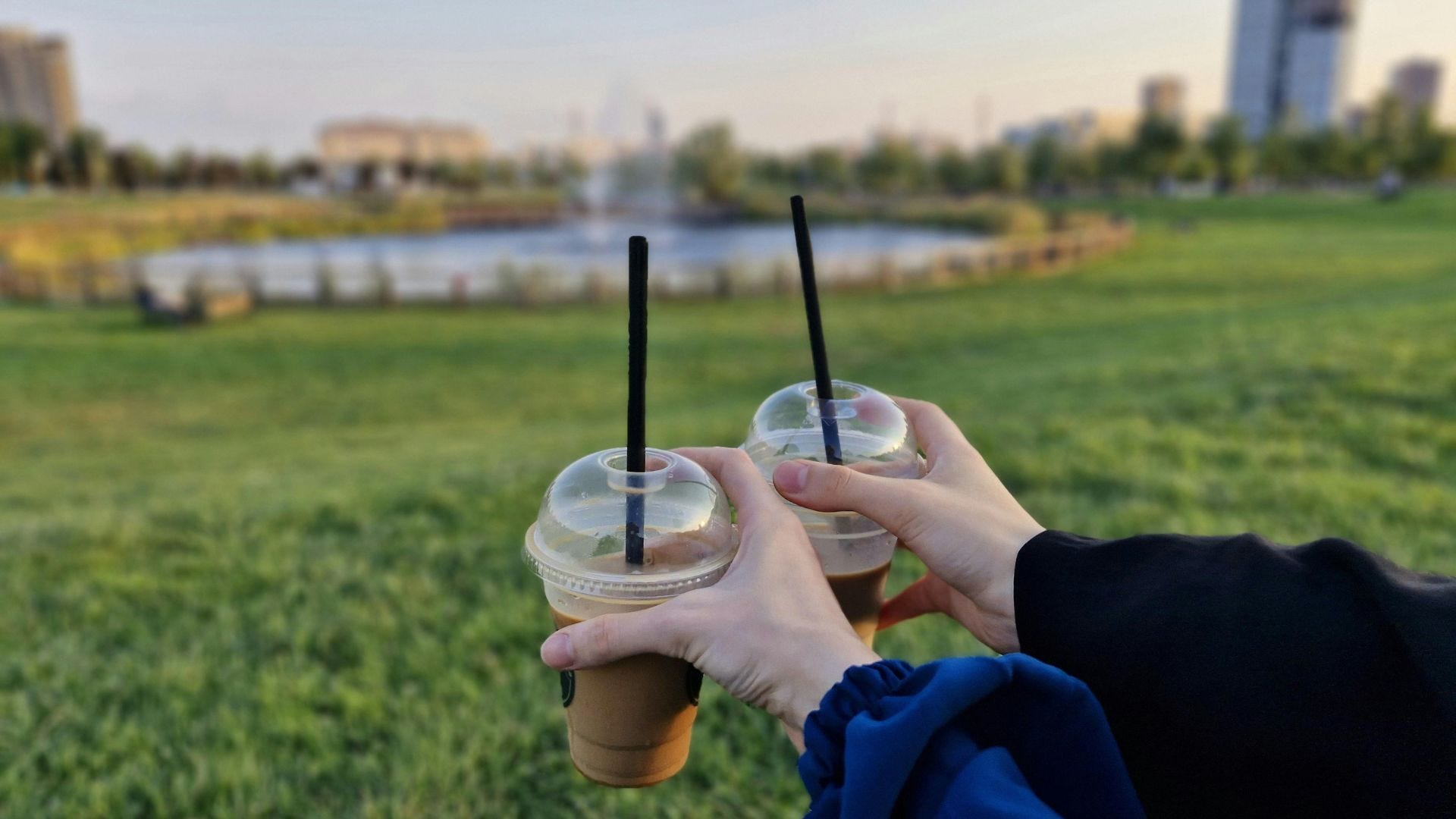 Person drinking a cup of coffee in the park