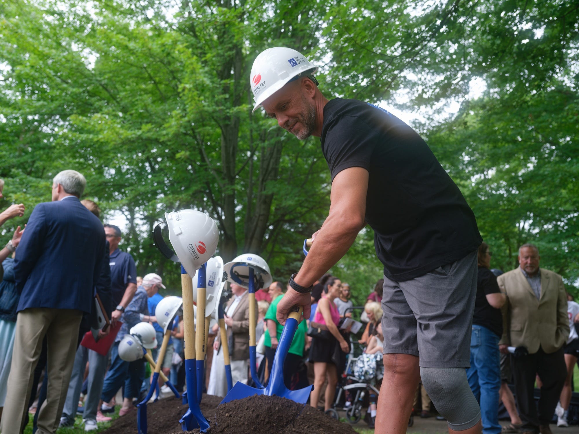Damian Buchman, founder and CEO of The Ability Center, is the first to turn a shovelful of soil at the groundbreaking of Moss Universal Park in Wauwatosa, Wisconsin.