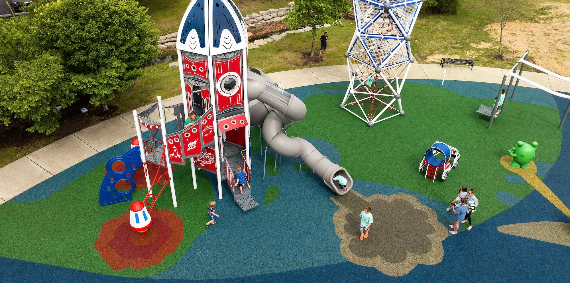 Playground with rocket ship tower and custom playground surfacing