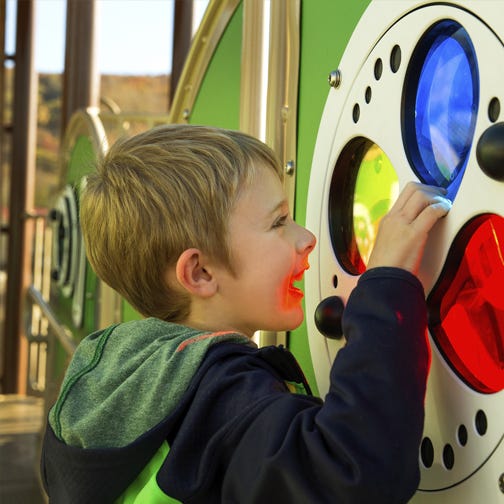 Child looking through a visual sensor that resembles stained glass