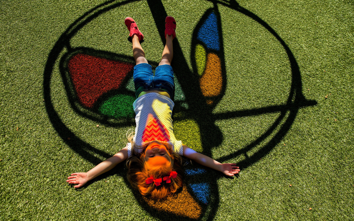 Synthetic Turf Artificial grass with play sculptures of a cheetah and hippo in the background
