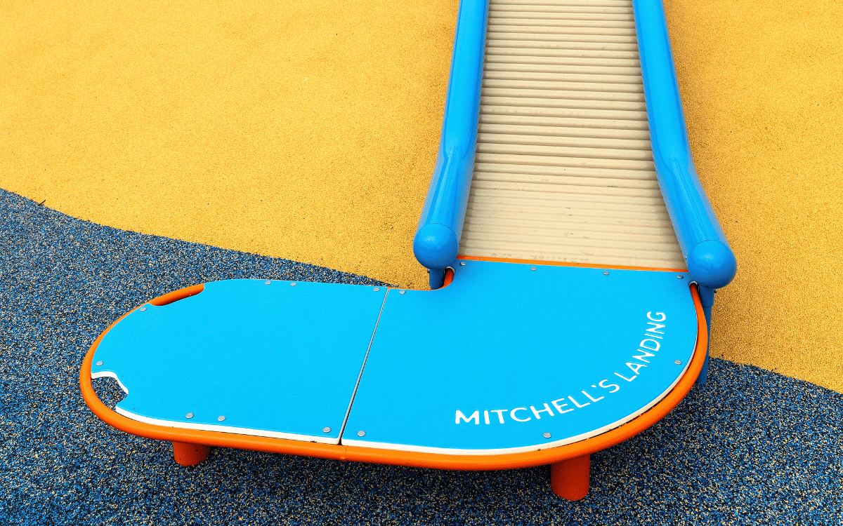 Two children swinging while facing each other in opposing swings