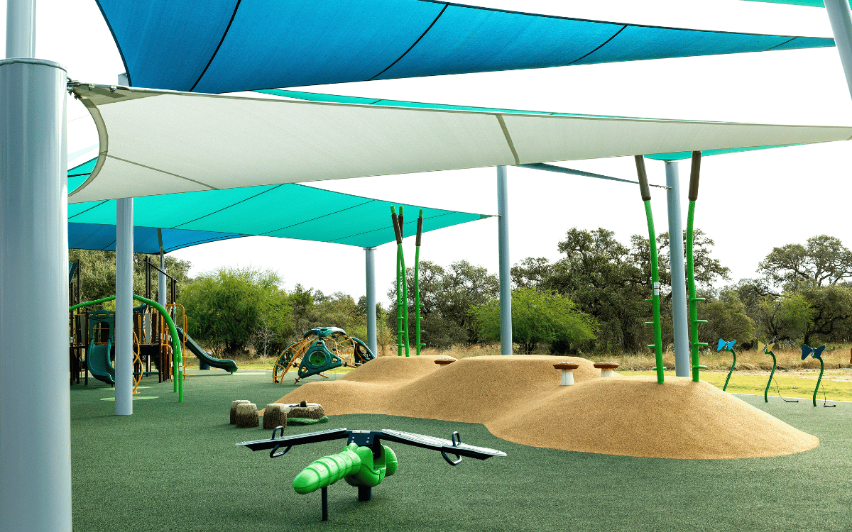 Mother and child swinging while facing each other in opposing swings