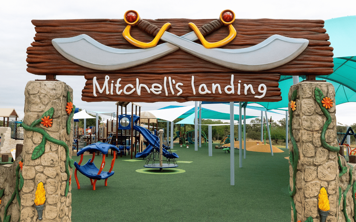 Mother and son swinging while facing each other in opposing swings
